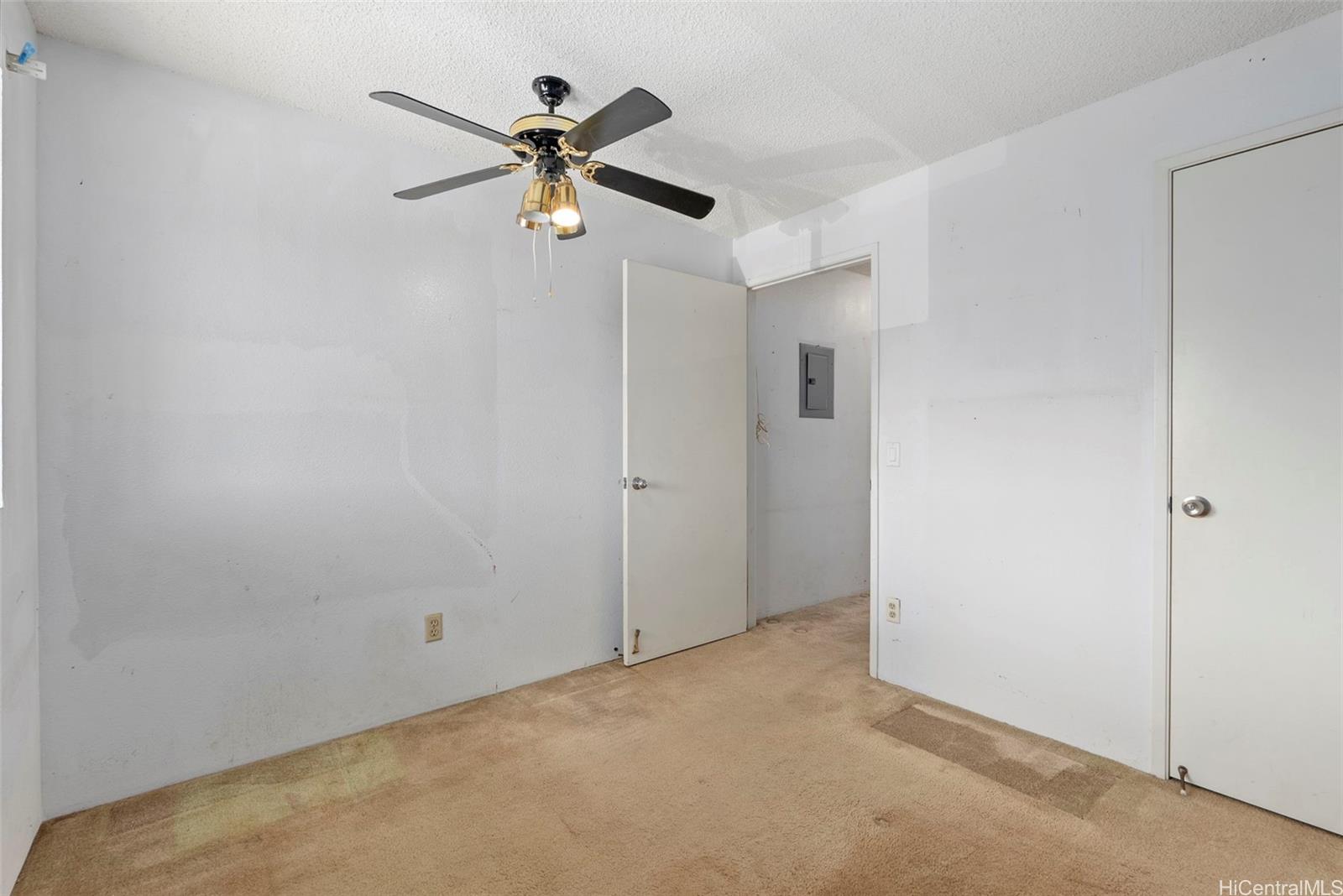 94-201 Lumiaina Place, Unit E202 Waipahu, HI 96797 - Photo 17 of 25 a view of a hallway with a ceiling fan
