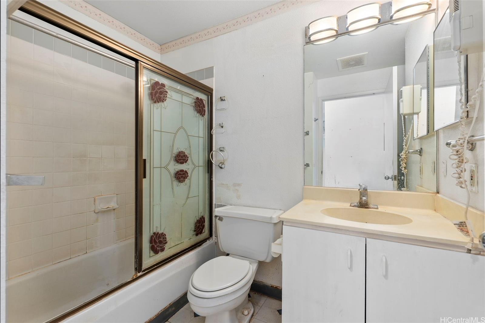 94-201 Lumiaina Place, Unit E202 Waipahu, HI 96797 - Photo 18 of 25 a bathroom with a sink toilet and shower