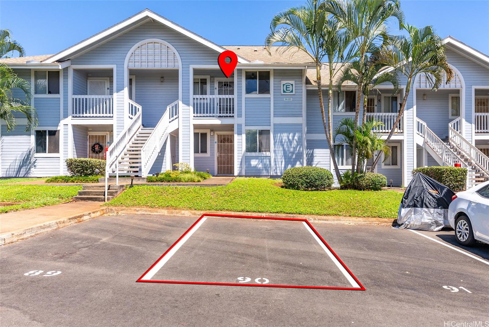 94-201 Lumiaina Place, Unit E202 Waipahu, HI 96797 - Photo 24 of 25 a front view of a house with a yard and garage