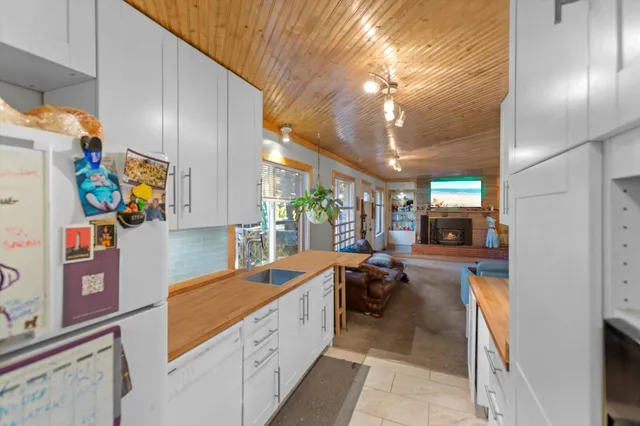 a roof deck with table and chairs and potted plants