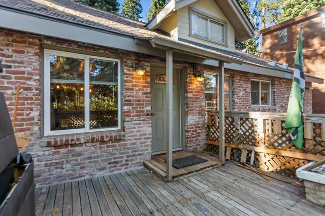 a view of a brick house with large windows