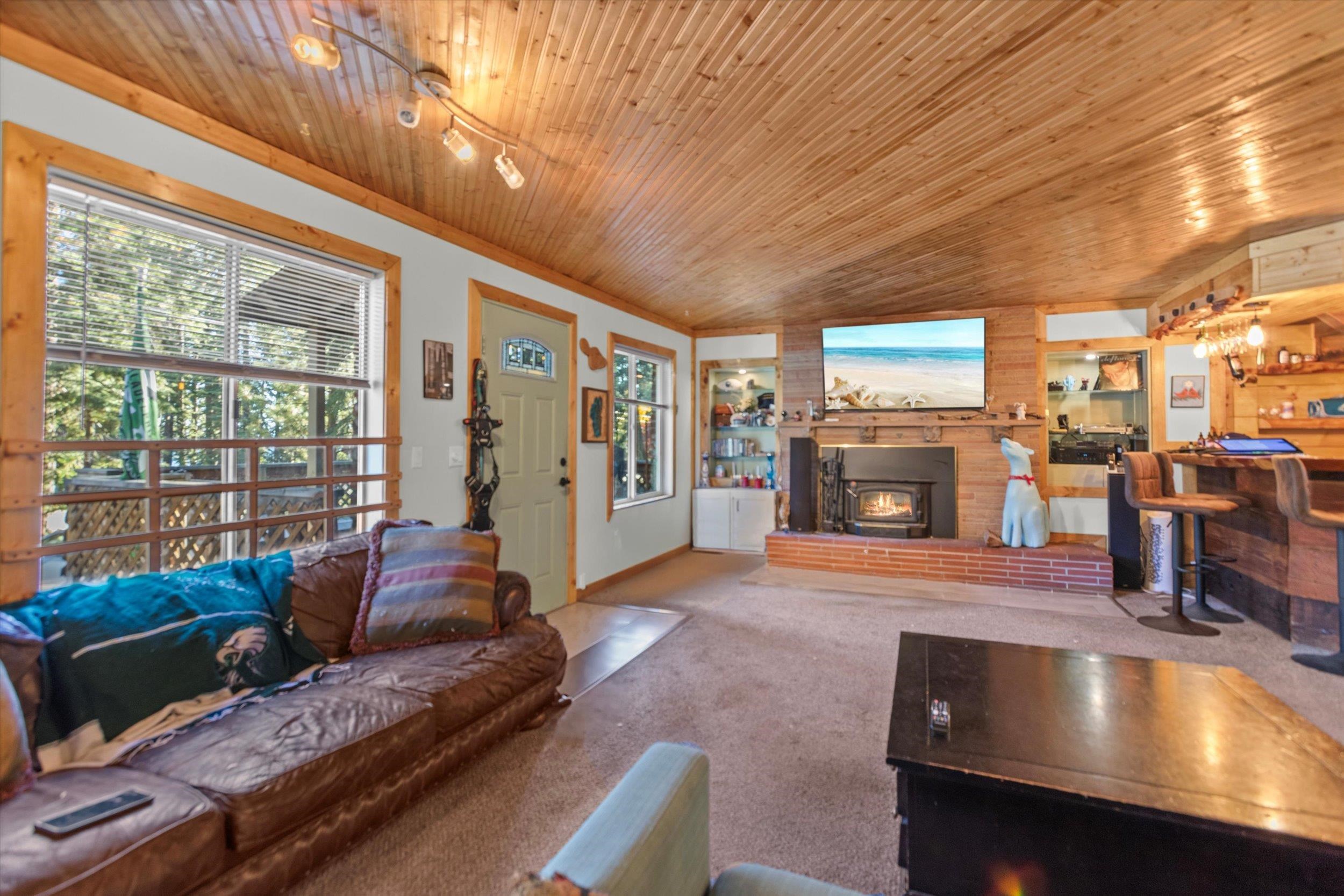 4115 North Lake Boulevard Carnelian Bay, CA 96140 - Photo 6 of 28 a living room with furniture and a fireplace