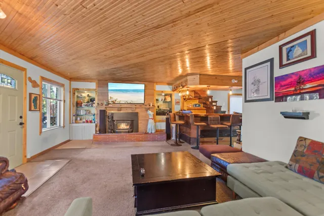 a living room with furniture pool table and flat screen tv