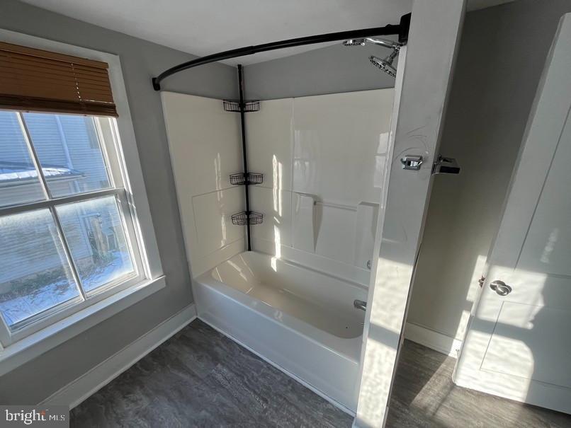 81 Main Street Yorkana, PA 17406 - Photo 14 of 16 a view of walk in closet with wooden floor and windows