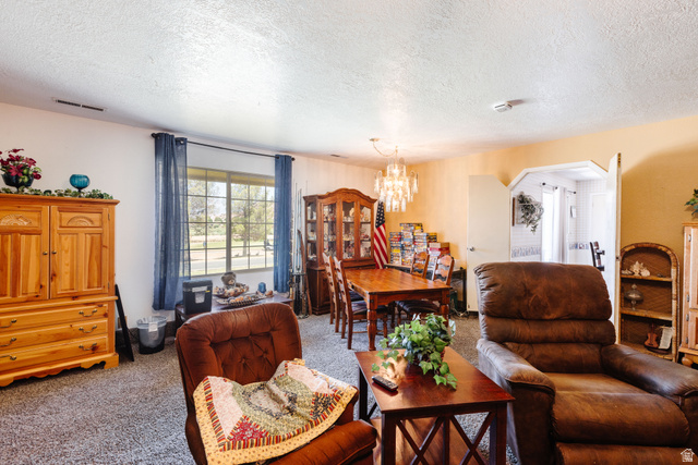 1470 Redwood Tree Street St. George, UT 84790 - Photo 22 of 53 Carpeted living area featuring a large window, recessed lighting, and an overhead lighting fixture