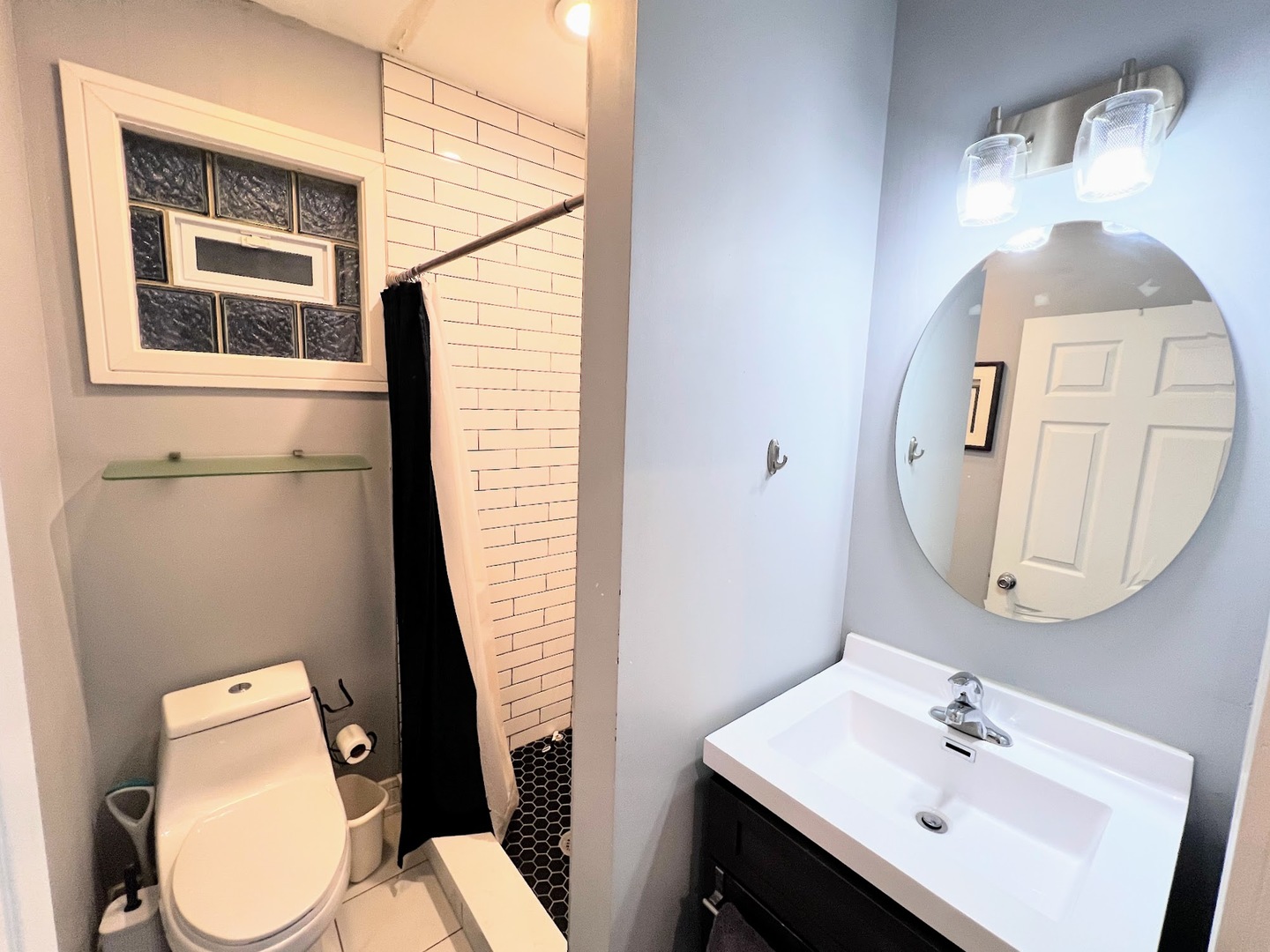113 South Paulina Street, Unit 3 Chicago, IL 60612 - Photo 11 of 13 a bathroom with a toilet sink and mirror