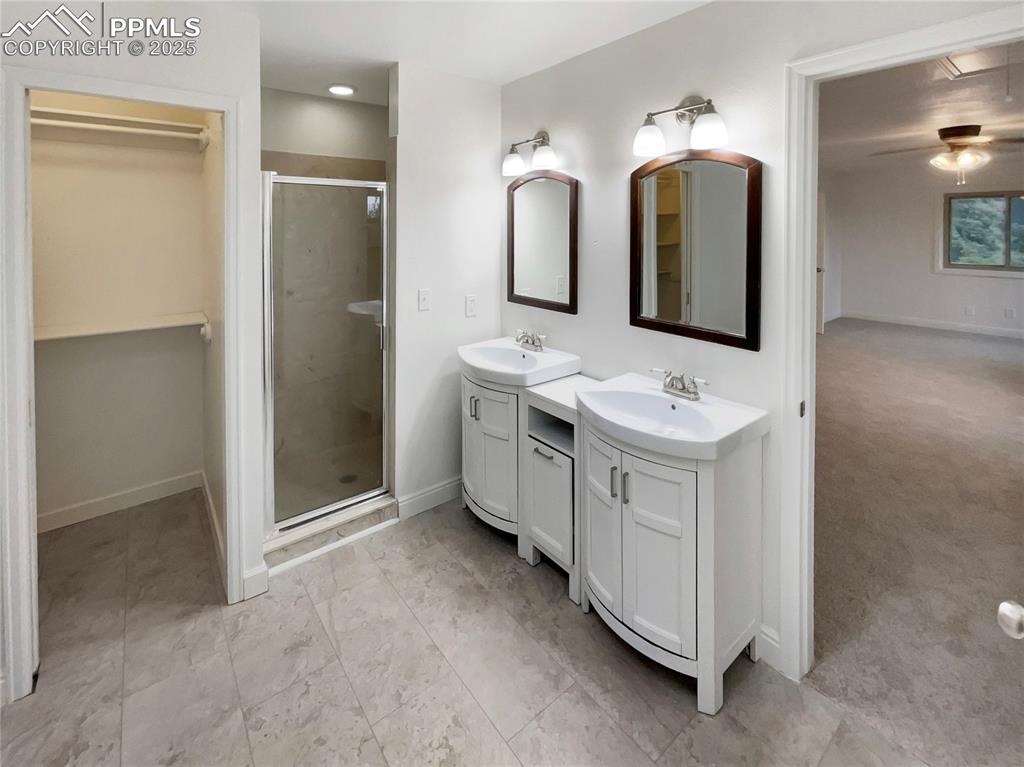 570 Ore Cart Way Monument, CO 80132 - Photo 14 of 22 a bathroom with a double vanity sink and mirror