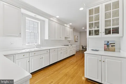a kitchen with a sink window and cabinets