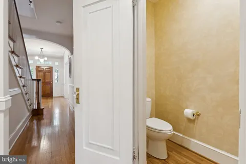a bathroom with a granite countertop toilet and a shower