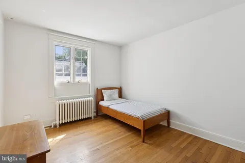 a room with two beds and a window
