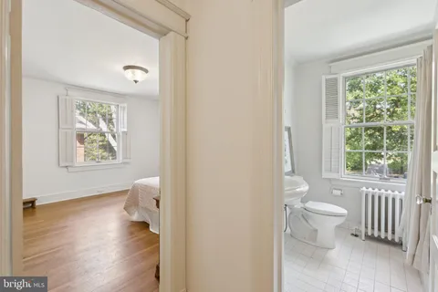 a bathroom with a toilet sink and a window