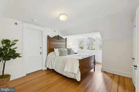 a bed room with a bed and a potted plant