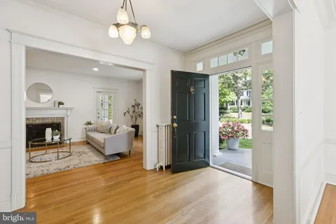 a view of a livingroom with wooden floor and a fireplace