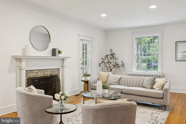 a living room with furniture a fireplace and a large mirror
