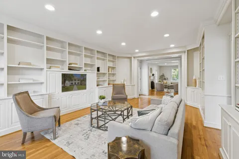 a living room with furniture a rug and a flat screen tv