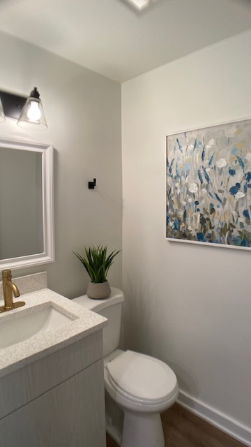 1908 Green Bay Road, Unit H Highland Park, IL 60035 - Photo 5 of 9 a bathroom with a toilet sink and mirror