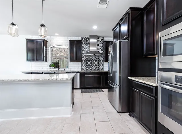 a bedroom with a large bed couch and a large window