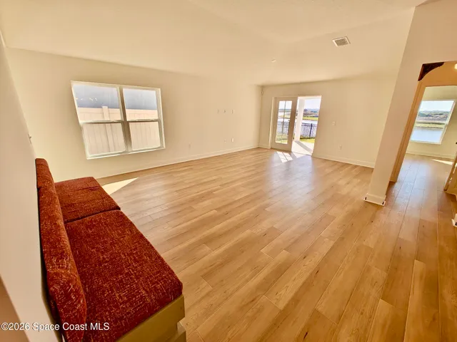 a view of a kitchen with kitchen island a counter top space a sink stainless steel appliances and cabinets