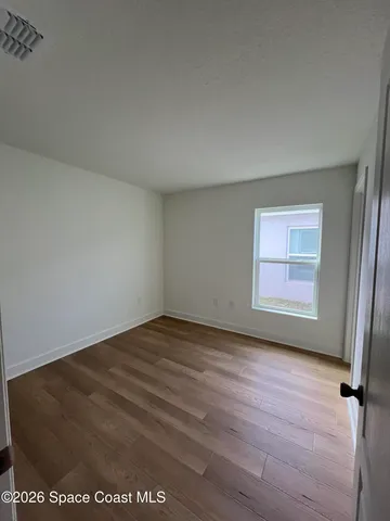 a bathroom with a granite countertop sink a toilet and a mirror