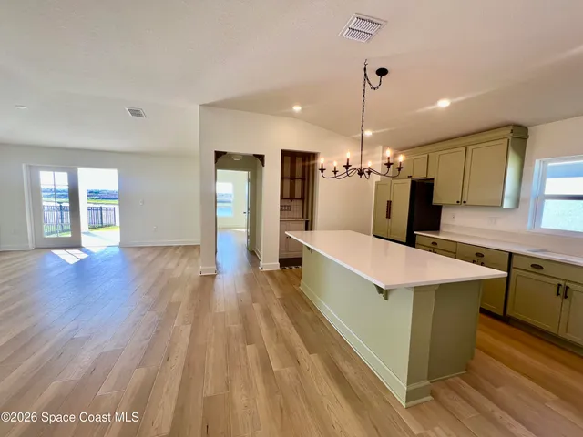a large kitchen with stainless steel appliances kitchen island a large island in the center