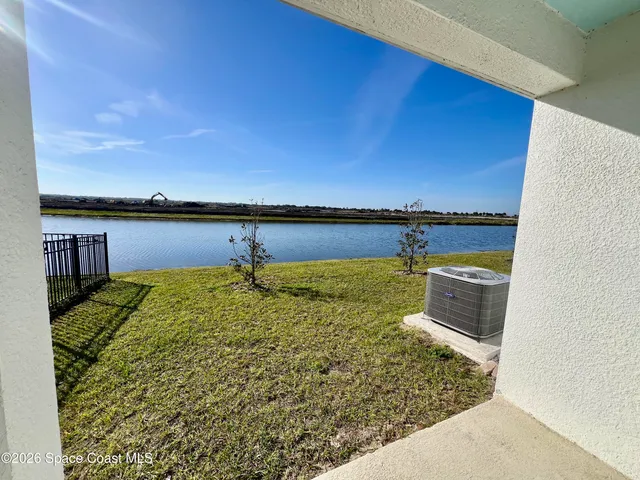 a view of entryway with paintings on the walls