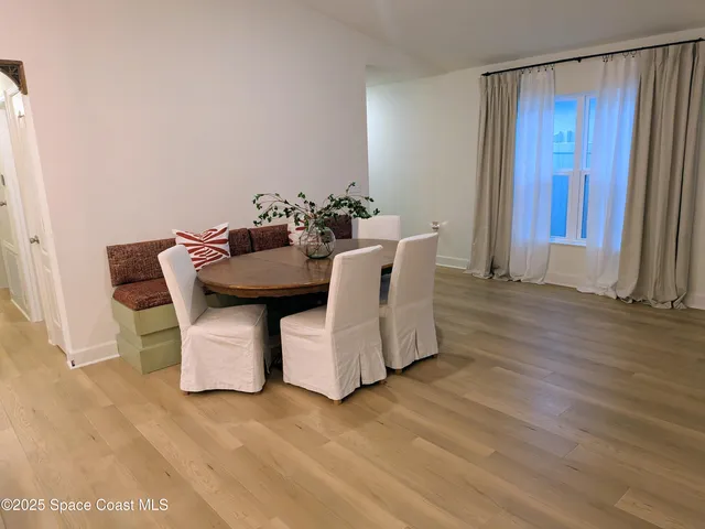 a kitchen with stainless steel appliances a refrigerator sink and wooden floor