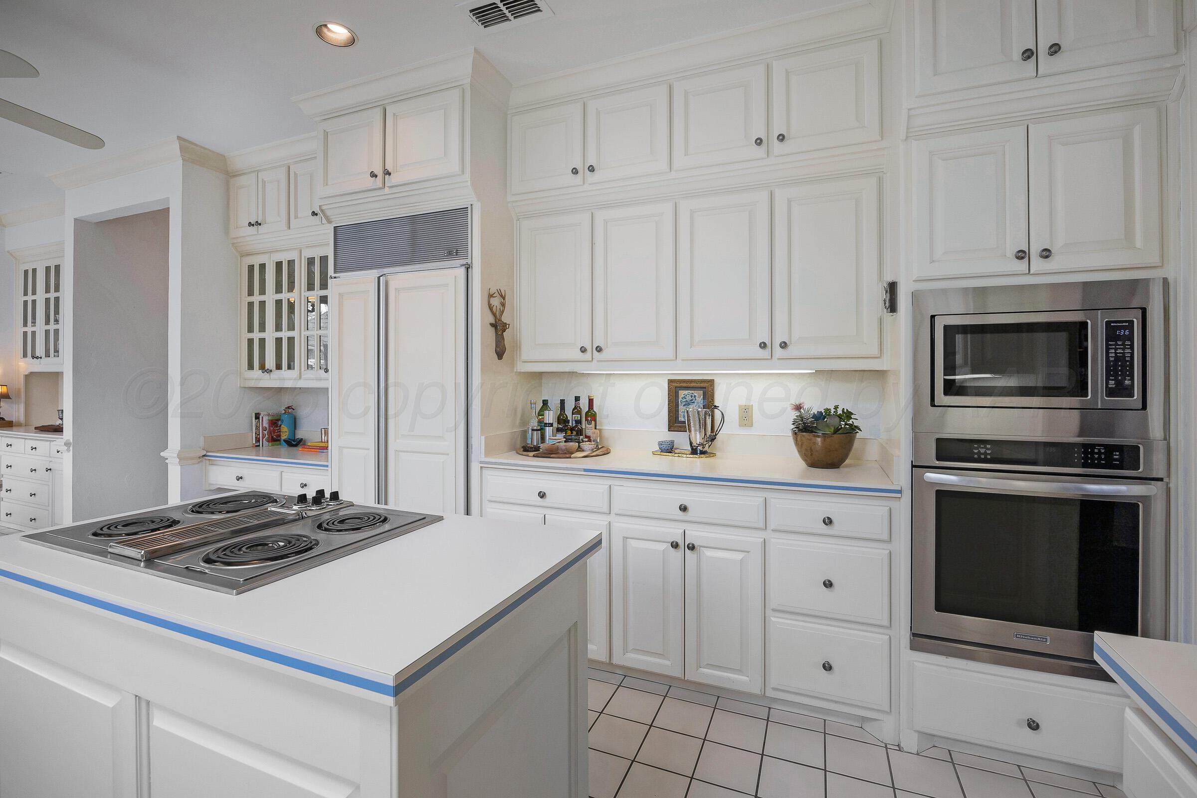 1 Gunn Court Amarillo, TX 79106 - Photo 16 of 36 a kitchen with white cabinets and appliances