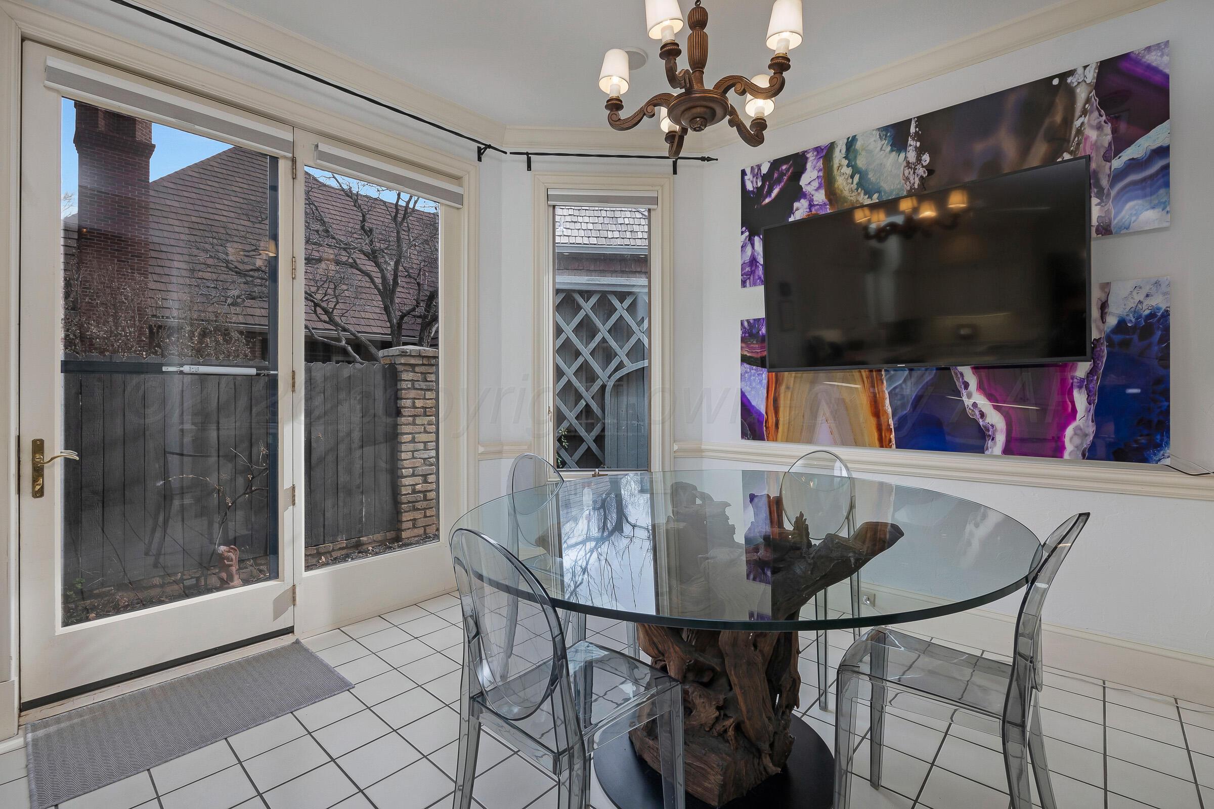 1 Gunn Court Amarillo, TX 79106 - Photo 19 of 36 a view of a dining room with furniture a chandelier and wooden floor