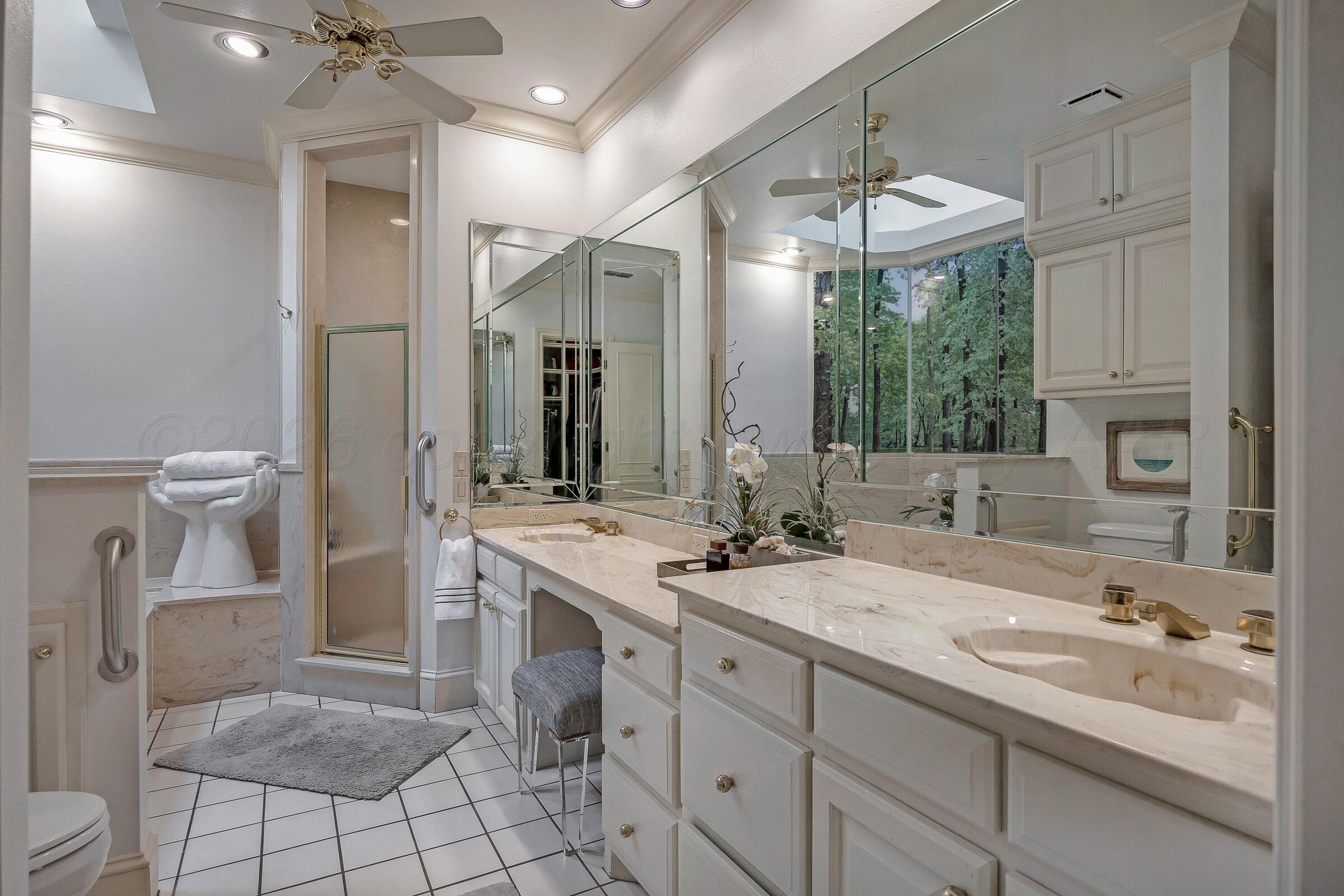 1 Gunn Court Amarillo, TX 79106 - Photo 23 of 36 a bathroom with a sink a toilet and a mirror