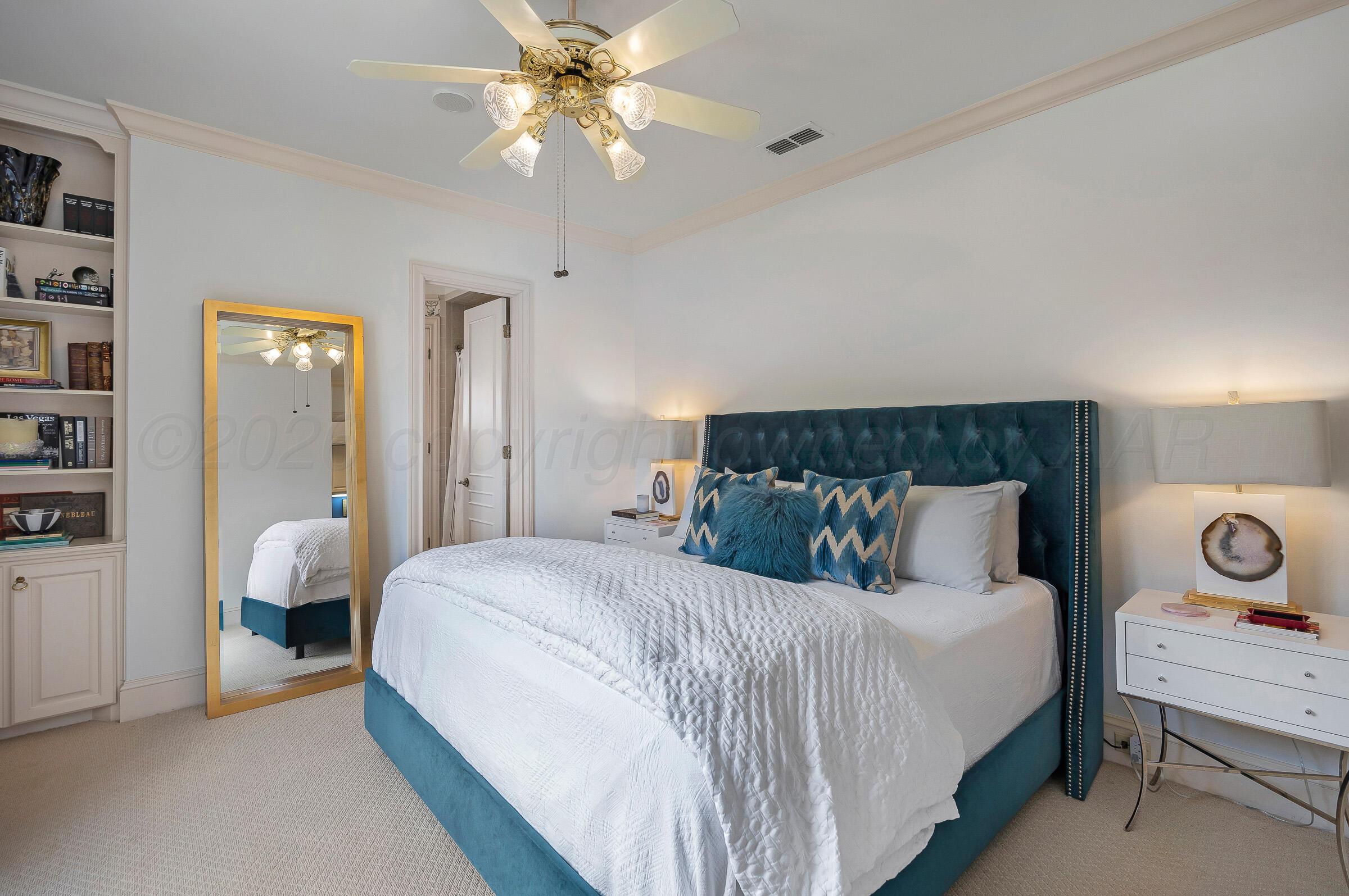 1 Gunn Court Amarillo, TX 79106 - Photo 27 of 36 a bedroom with a bed and a chandelier