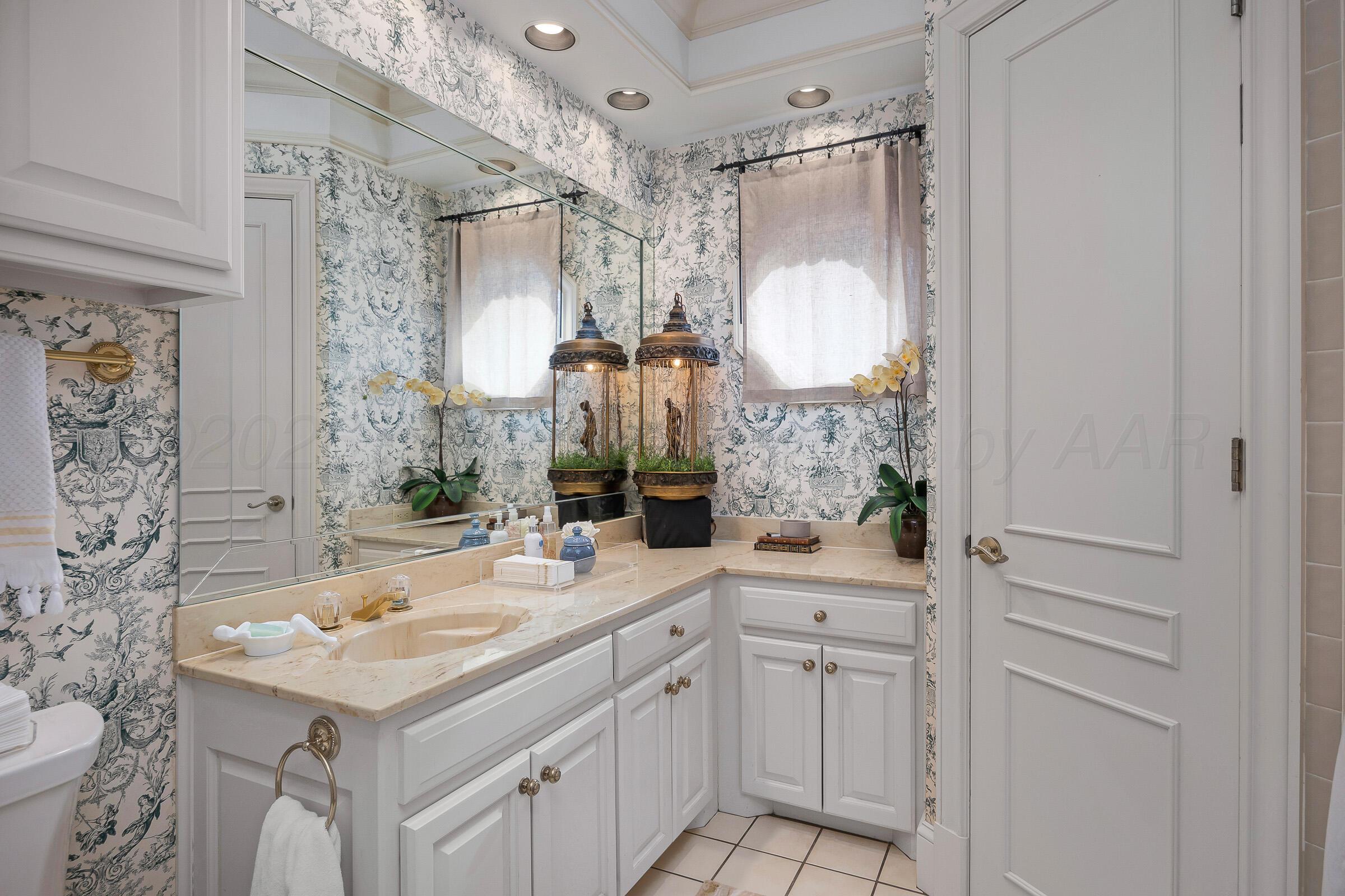 1 Gunn Court Amarillo, TX 79106 - Photo 28 of 36 a bathroom with a sink vanity granite and a mirror
