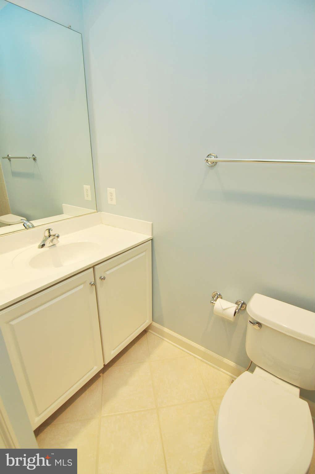 719 Carpenter Road Alexandria, VA 22314 - Photo 21 of 26 a white toilet sitting next to a bathroom sink