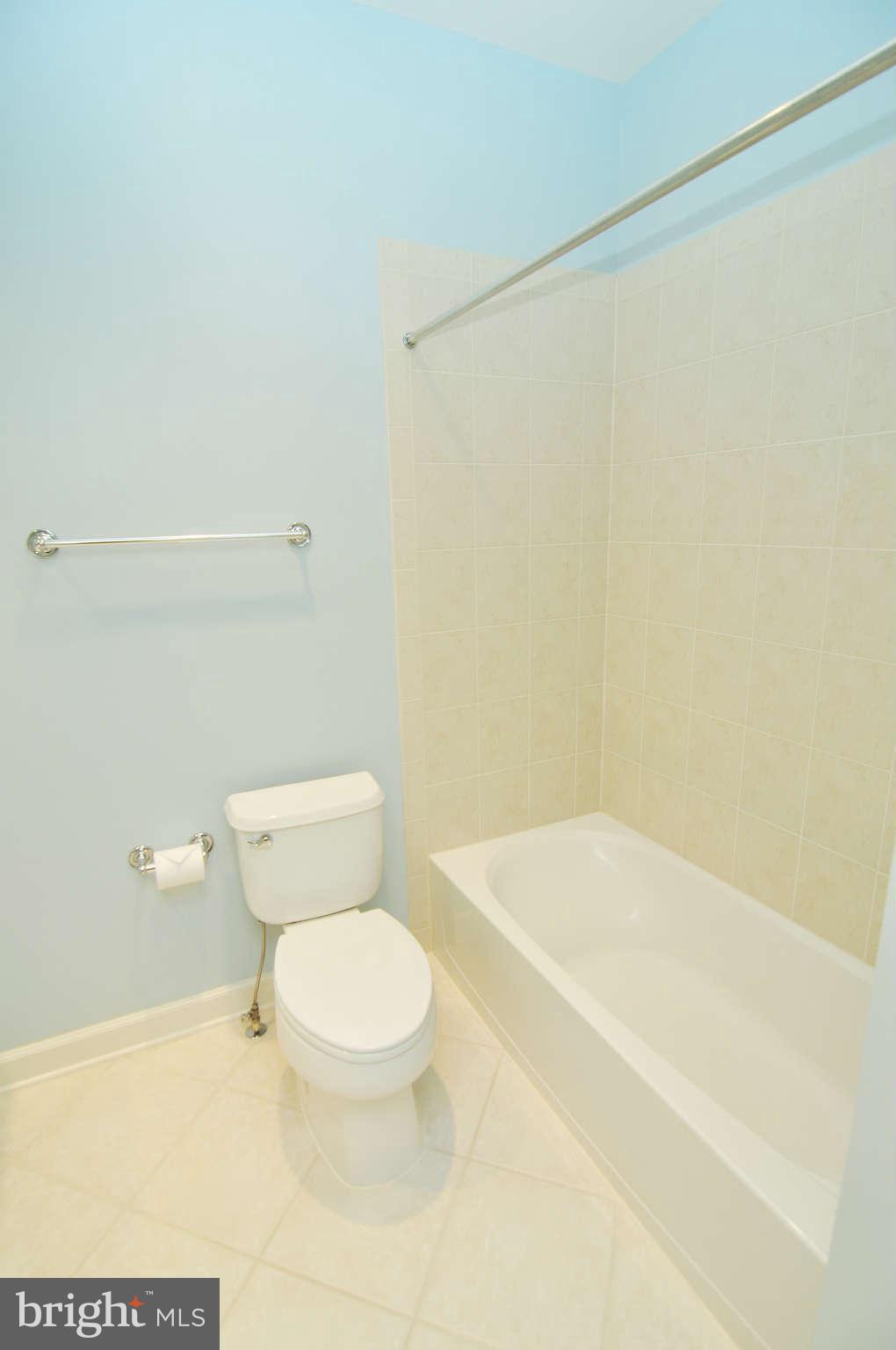719 Carpenter Road Alexandria, VA 22314 - Photo 22 of 26 a white toilet sitting next to a bath tub