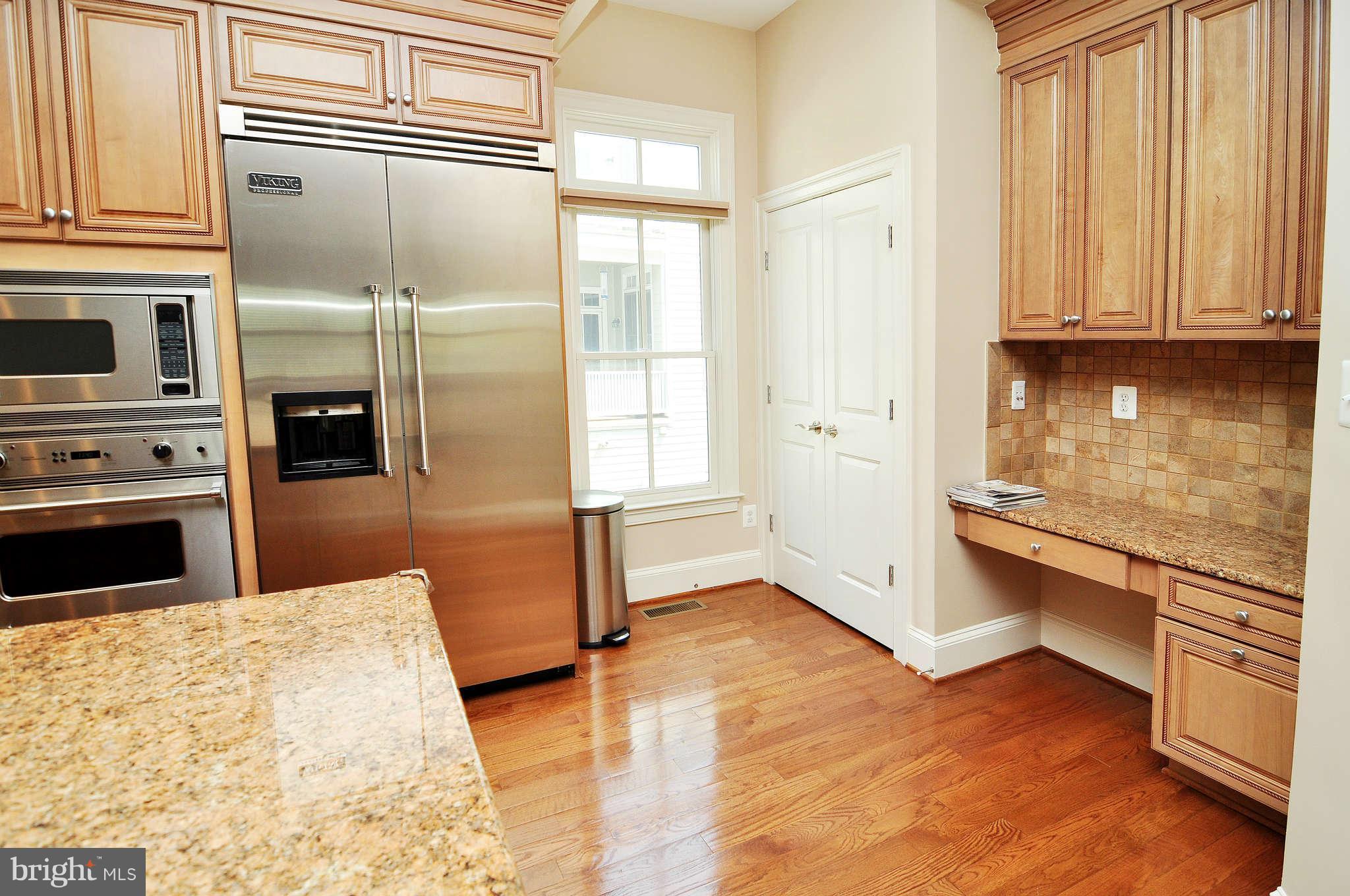 719 Carpenter Road Alexandria, VA 22314 - Photo 8 of 26 a kitchen with stainless steel appliances granite countertop a refrigerator and a stove top oven