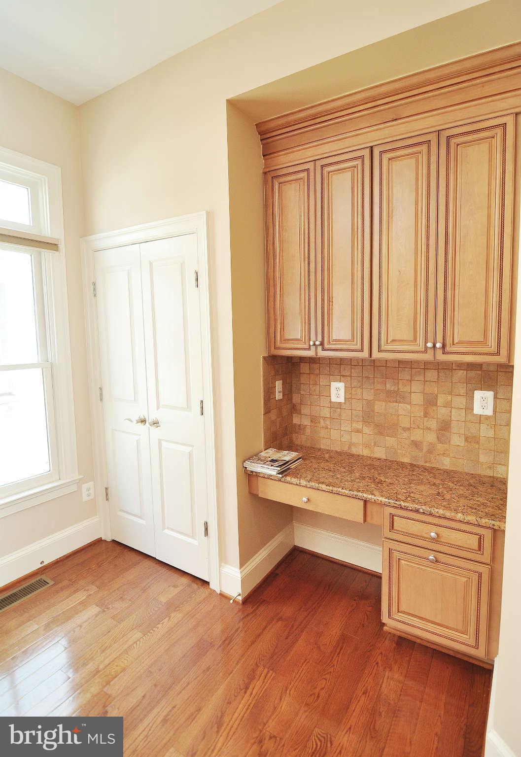 719 Carpenter Road Alexandria, VA 22314 - Photo 9 of 26 a view of a kitchen with wooden floor and cabinets