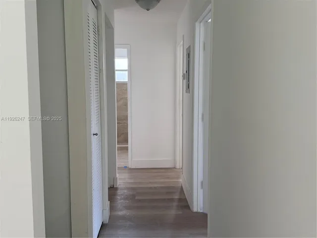 a view of an empty room and a window