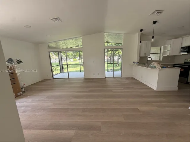 a kitchen with a sink cabinets and window