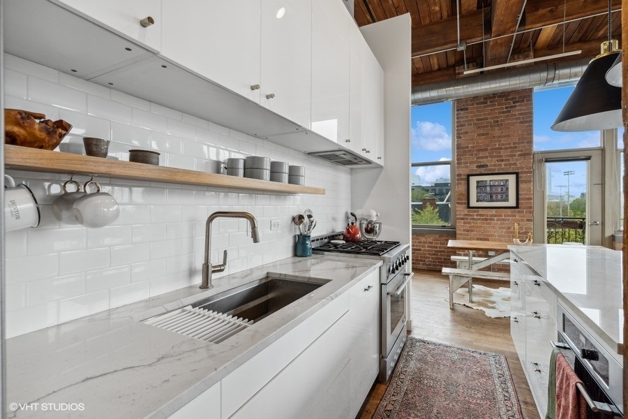 1500 West Monroe Street, Unit 425 Chicago, IL 60607 - Photo 11 of 33 a kitchen with stainless steel appliances granite countertop a sink stove and cabinets