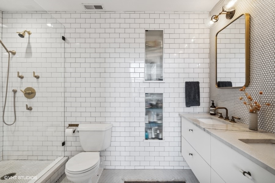 1500 West Monroe Street, Unit 425 Chicago, IL 60607 - Photo 19 of 33 a bathroom with a sink a toilet and shower