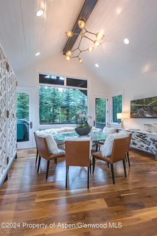 a living room with furniture a rug and a large window