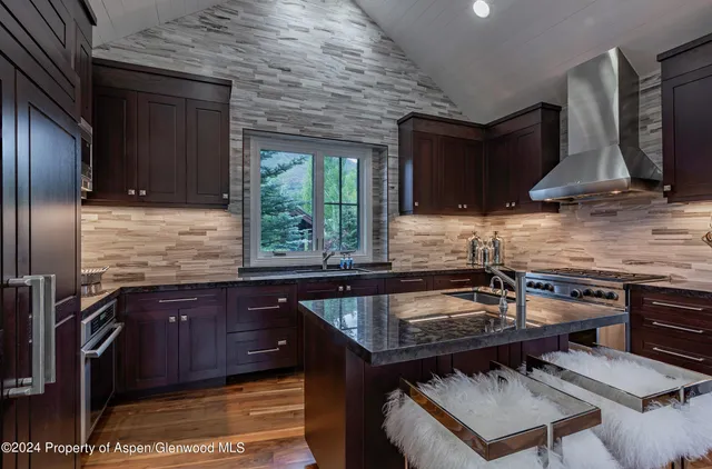a kitchen with a sink stove and microwave