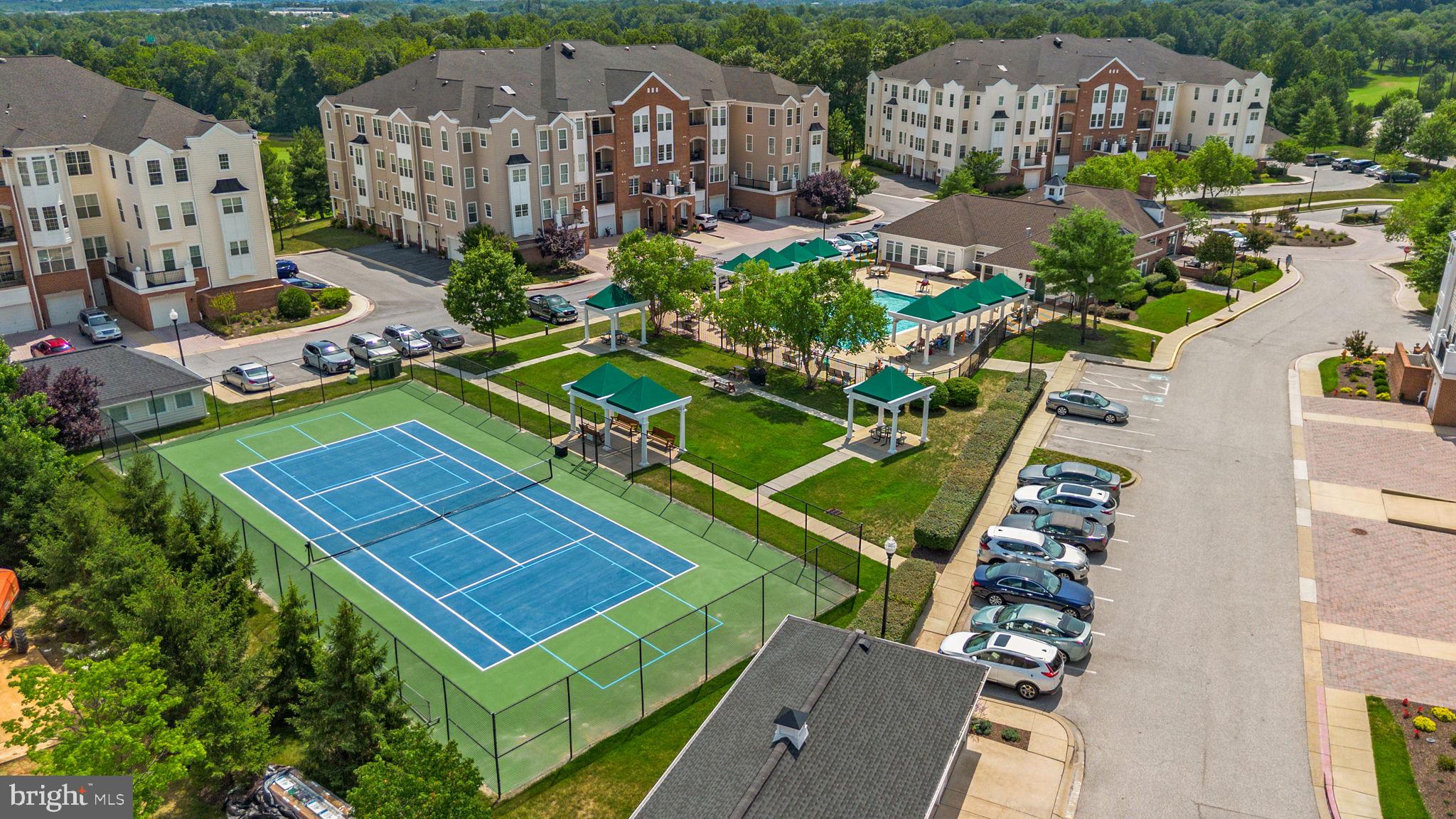 7315 Maplecrest Road, Unit 104 Elkridge, MD 21075 - Photo 50 of 58 an aerial view of a tennis ground with a white house