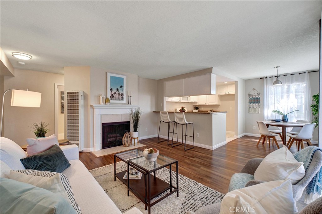 1401 North Greenbrier Road, Unit 104 Long Beach, CA 90815 - Photo 1 of 1 a living room with furniture and a fireplace