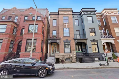a car parked in front of a brick building