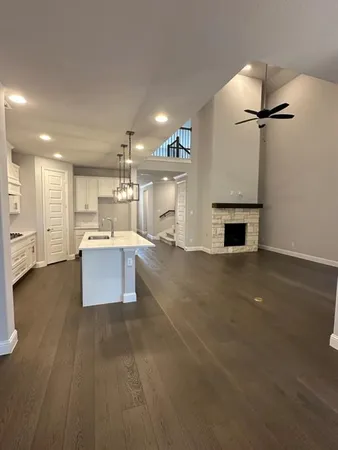 a large kitchen with a large counter top appliances and cabinets