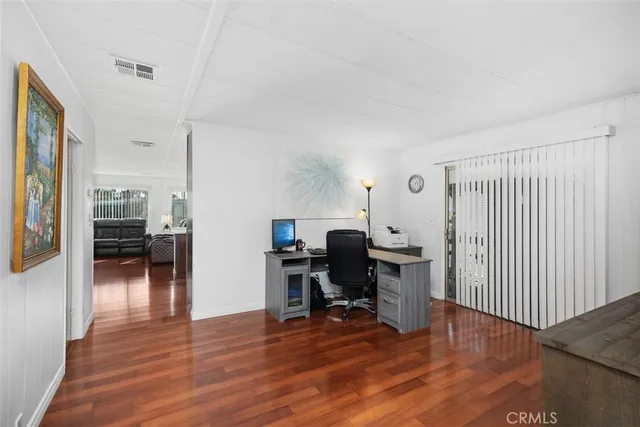 a view of a workspace with furniture and wooden floor