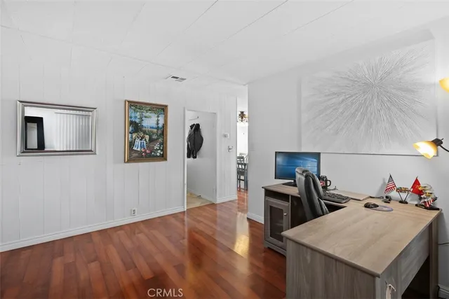 a view of a workspace with furniture and wooden floor