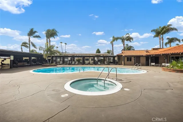 a view of swimming pool with outdoor seating and city view