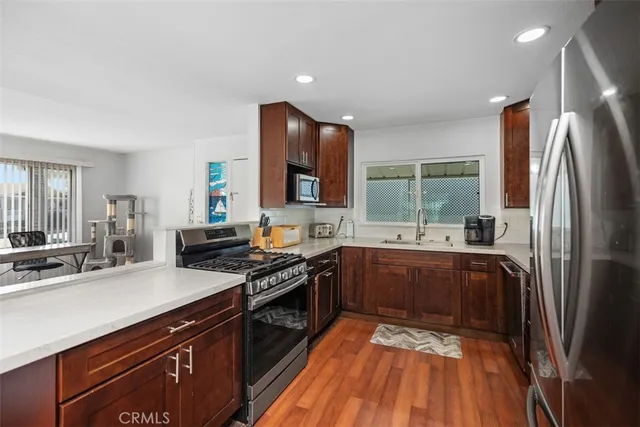 a kitchen with stainless steel appliances granite countertop a sink stove and refrigerator
