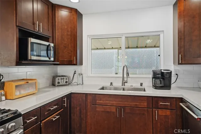 a kitchen with sink and cabinets